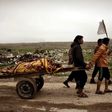 Relatives transport the bodies of west Mosul residents allegedly killed in an airstrike targeting Islamic State group jihadists on March 17, 2017