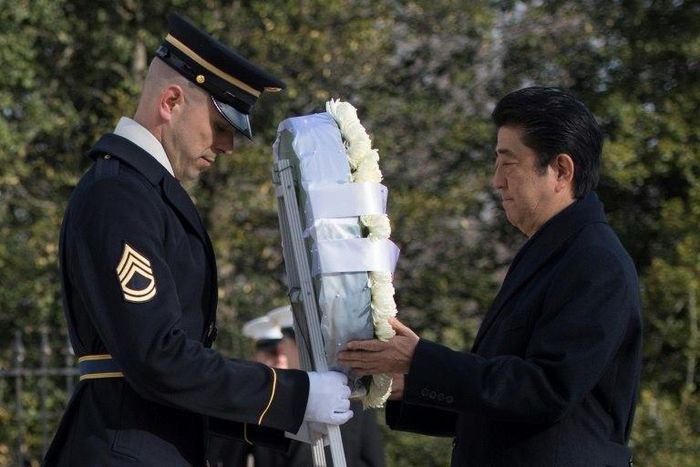 Japanese Prime Minister Shinzo Abe lays a wreath at the Tomb of the Unknown Soldier at Arlington National Cemetery, in Virginia, on February 10, 2017