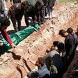 Syrians dig a grave to bury the bodies of victims of a a suspected chemical attack in Khan Sheikhun, a rebel-held town in Syria’s northwestern Idlib