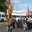 Demonstrators carrying a banner reading "Association of Former Mozambican Workers in Germany" march in Maputo over unpaid wages
