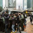 A media scrum greets former Hong Kong leader Donald Tsang as he arrives at court to hear his 20-month prison sentence for misconduct in office
