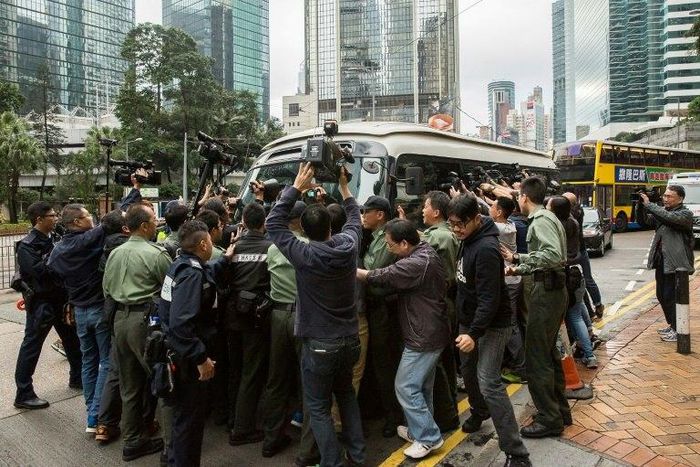 A media scrum greets former Hong Kong leader Donald Tsang as he arrives at court to hear his 20-month prison sentence for misconduct in office