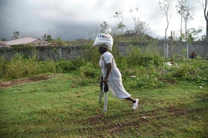 Sara, 66, receives food from the World Food Programme in the commune of Maniche, in Haiti, last month