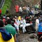 Rescuers carry a corpse following deadly mudslides in the central Colombian city of Manizales