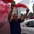 A taxi driver brandishes smoke canisters as he protests in Madrid