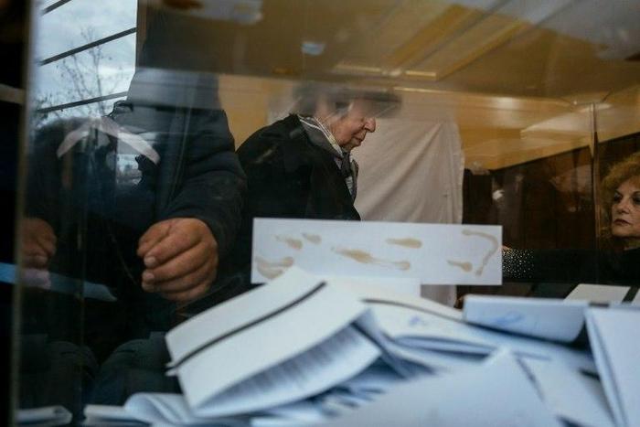 People cast their ballot in the presidential elections at a polling station in Pleven on November 6, 2016