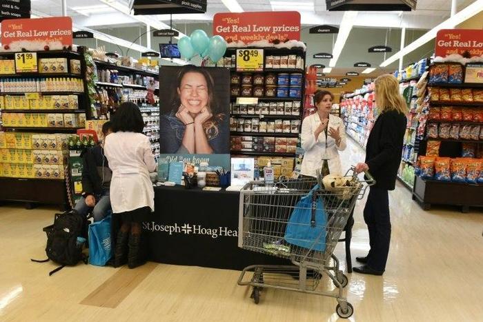 Medical workers take blood pressure and talk with shoppers about healthy eating choices as part of the "Shop with a Doc" program at a Ralph's Supermarket in Irvine, California