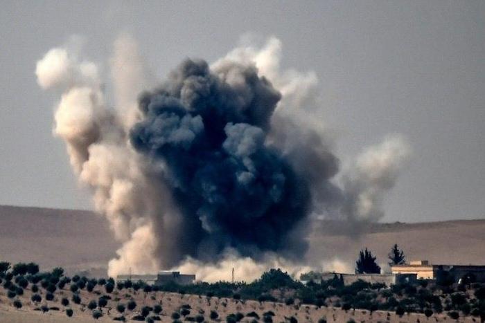 An air strike by a Turkish jet fighter hits the Syrian village of Jarabulus on the Syrian-Turkish border during fighting against the IS group on August 24, 2016