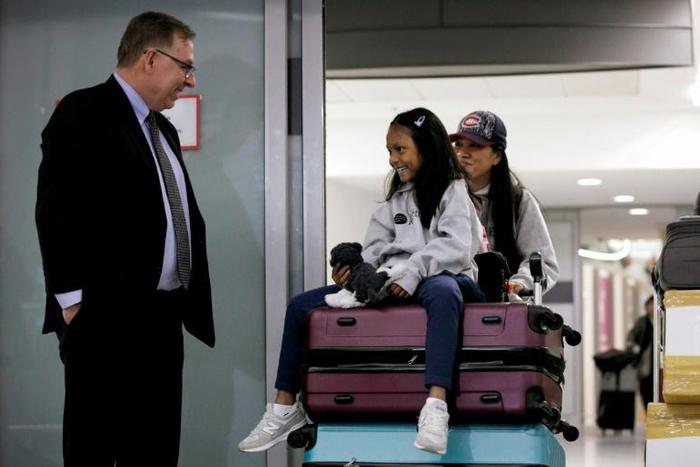 Lawyer Robert Tibbo greets Vanessa Rodel and her daughter Keana as the pair arrive in Canada at the Toronto airport on a flight from Hong Kong on March 25, 2019
