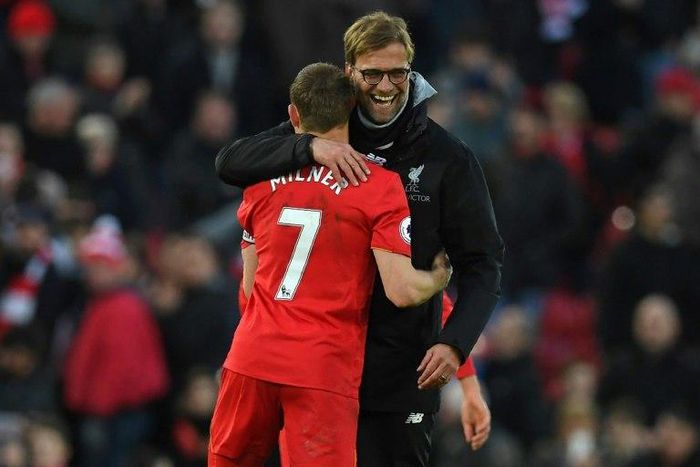 Liverpool's manager Jurgen Klopp (R) embraces midfielder James Milner at Anfield on March 12, 2017