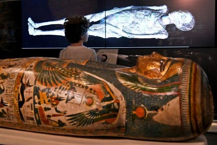 A young visitor looks at a 3D image of a CT scan of an Egyptian mummy, during a preview for a joint British-Australian exhibition in Sydney