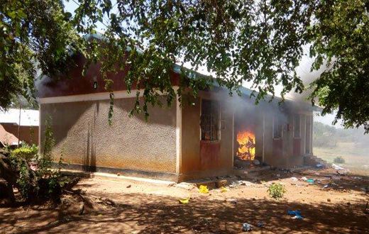One of the houses on fire after angry residents stormed a police station after suspect’s controversial death in cell