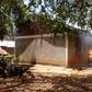 One of the houses on fire after angry residents stormed a police station after suspect’s controversial death in cell