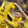 Dortmund's forward Marco Reus holds the jersey of teammate Marc Bartra, who was injured during an attack on the team's bus, after their match against Eintracht Frankfurt in Dortmund, western Germany, on April 15, 2017