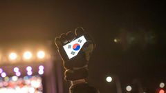 Human rights activists in South Korea, whose flag is displayed on a smartphone screen in this photo, say cases of sexual violence within the military occur persistently despite government efforts to curb them