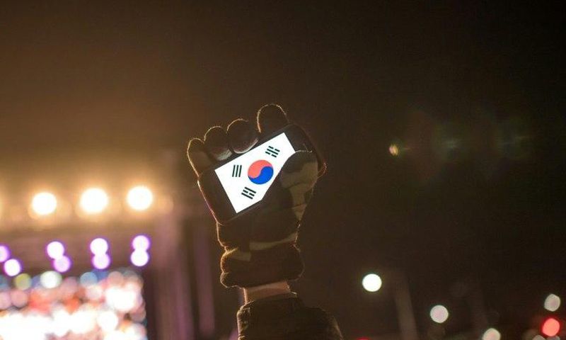 Human rights activists in South Korea, whose flag is displayed on a smartphone screen in this photo, say cases of sexual violence within the military occur persistently despite government efforts to curb them
