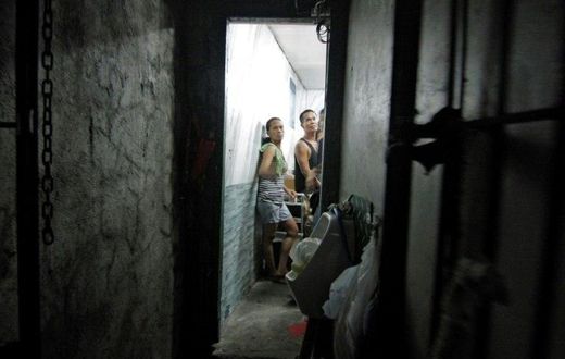 A dozen people have been found stuffed inside a closet-sized cell hidden behind a book shelf in a Philippine police station