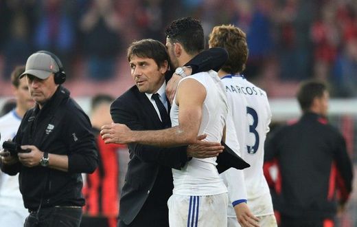 Chelsea's head coach Antonio Conte (L) embraces Chelsea's striker Diego Costa (R) at the end of the English Premier League football match between Bournemouth and Chelsea at the Vitality Stadium in Bournemouth, southern England on April 8, 2017