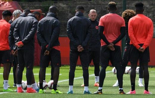 Manchester United players observe a minute's silence for the victims of yesterday's terror attack at the Manchester Arena, during a training session at the club's training complex near Carrington, on May 23, 2017