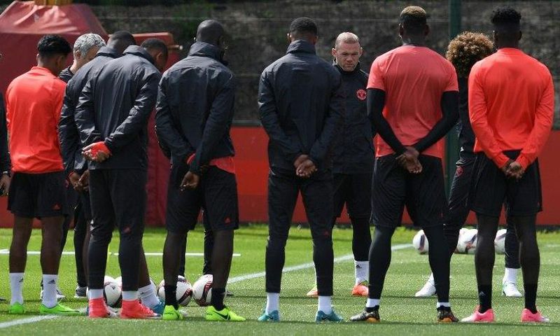 Manchester United players observe a minute's silence for the victims of yesterday's terror attack at the Manchester Arena, during a training session at the club's training complex near Carrington, on May 23, 2017