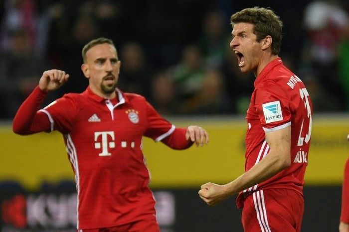 Bayern Munich's midfielder Thomas Mueller (R) celebrates a goal on March 19, 2017