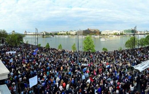 Tens of thousands demonstrated in Budapest against the controversial education legislation the day before it was signed, many chanting "Don't sign it, Janos!" and holding up placards reading "Veto!"