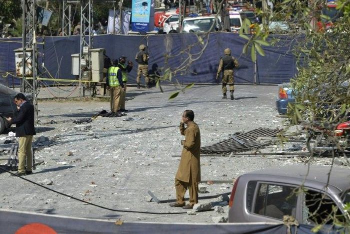 Pakistani security officials examine the site of a bomb attack in blast site in an upscale suburb of Lahore, on February 23, 2017