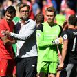 Liverpool's manager Jurgen Klopp (C) embraces defender Dejan Lovren after an English Premier League football match against Southampton on May 7, 2017