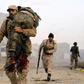 A member of the Libyan National Army (LNA) carries an injured comrade during fighting against jihadists in Qanfudah, on the southern outskirts of Benghazi