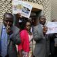 Kenyan Opposition Members of Parliament blow whistles and hold placards in protest as they leave the National Assembly during President Uhuru Kenyatta's annual State of the Nation address at the Parliament Buildings in Nairobi, March 31, 2016.