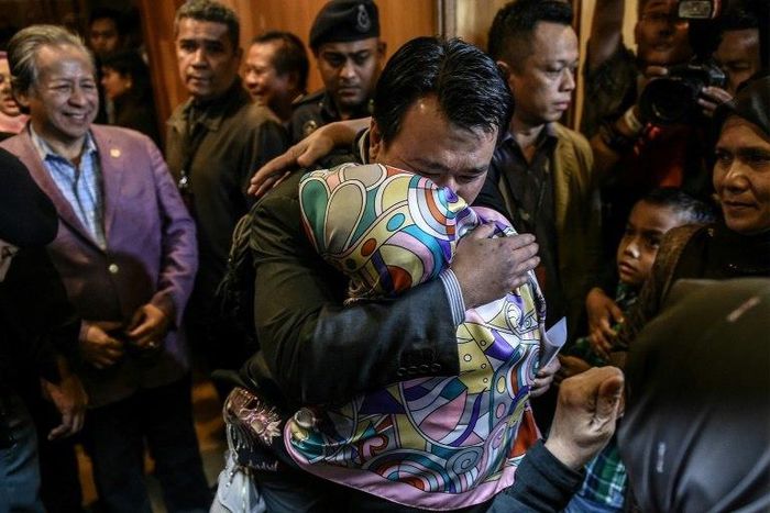 Malaysians freed by Pyongyang made an emotional return Friday after landing at Kuala Lumpur international airport