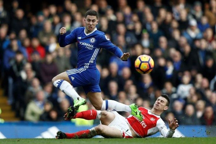 Arsenal's French defender Laurent Koscielny (R) cuts out a through ball intended for Chelsea's Belgian midfielder Eden Hazard (L) during the English Premier League football match between Chelsea and Arsenal at Stamford Bridge in London on February 4, 2...