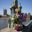 Floral tributes to the victims of the March 22 terror attack are seen on Westminster Bridge near the Houses of Parliament in central London
