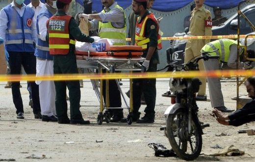 Pakistani security officials collect evidence from the scene of an attack on a census team in Lahore