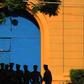 Sri Lankan policemen stand guard in front of protesters outside the main prison in Colombo on August 8, 2011