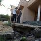 Libyans examine the site where a mortar shell landed in Tripoli during a previous round of deadly clashes between militias on August 30, 2018