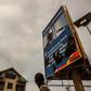 Demonstrators point to a broken billboard showing the face of Congolese President Joseph Desiree Kabila during an opposition rally in Kinshasa on September 19, 2016