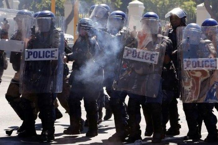 South African Police attend a protest outside Parliament in Cape Town