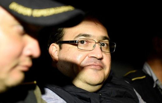 Javier Duarte (C), former governor of the Mexican state of Veracruz, in a police patrol car following his arrest upon his arrival at the Matamoros military barracks in Guatemala City on April 16, 2017