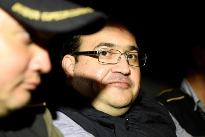Javier Duarte (C), former governor of the Mexican state of Veracruz, in a police patrol car following his arrest upon his arrival at the Matamoros military barracks in Guatemala City on April 16, 2017