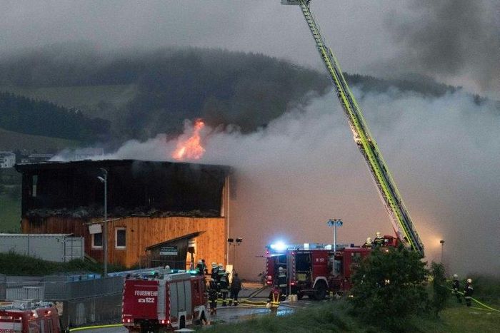 Firemen extinguish a fire at a newly-built asylum seeker centre in Altenfelden, northern Austria, on June 1, 2016, with arson suspected