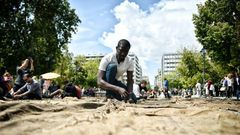 Ghanian artist Ibrahim Mahama performs "Check Point - Prosfygika" on the main Syntagma square in Athens on April 7, 2017 on the eve of the opening of the 14th edition of the Documenta 14 art exhibition
