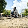 Ghanian artist Ibrahim Mahama performs "Check Point - Prosfygika" on the main Syntagma square in Athens on April 7, 2017 on the eve of the opening of the 14th edition of the Documenta 14 art exhibition