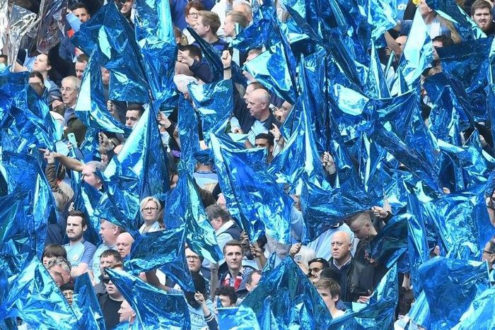 Manchester City fans cheer during the FA Cup semi-final football match against Arsenal at Wembley stadium in London on April 23, 2017