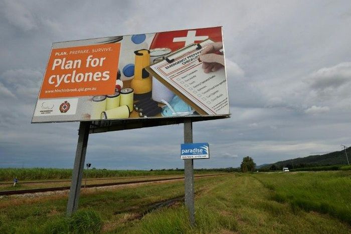 A warning sign is seen outside the city of Townsville in far north Queensland, where thousands of people are being evacuated as Cyclone Debbie approaches