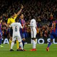 German referee Deniz Aytekin (C) shows a yellow card to Paris Saint-Germain's midfielder Blaise Matuidi (2ndR) during their UEFA Champions League round of 16 second leg football match at the Camp Nou stadium in Barcelona on March 8, 2017
