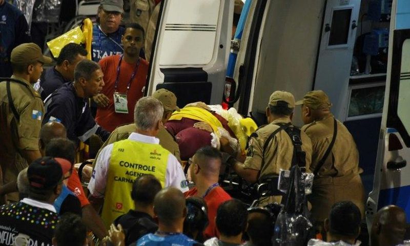 A woman is carried into an ambulance after being struck by the Paraiso do Tuiuti samba school float at the entrance of the Sambadrome during the first night of the Rio Carnival on February 26, 2017