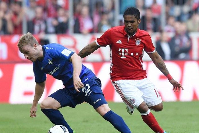 Darmstadt’s Fabian Holland (left) and Bayern Munich's Douglas Costa in action during a Bundesliga match in Munich, on May 6, 2017