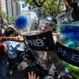An estimated 1,000 people scuffled with police as they tried to march to Venezuela's National Assembly to demand the government restore powers to its opposition majority