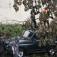 Malagasy firefighters work to remove a fallen tree from a car caused by tropical cyclone Enawo in Antananarivo, Madagascar, on March 8, 2017